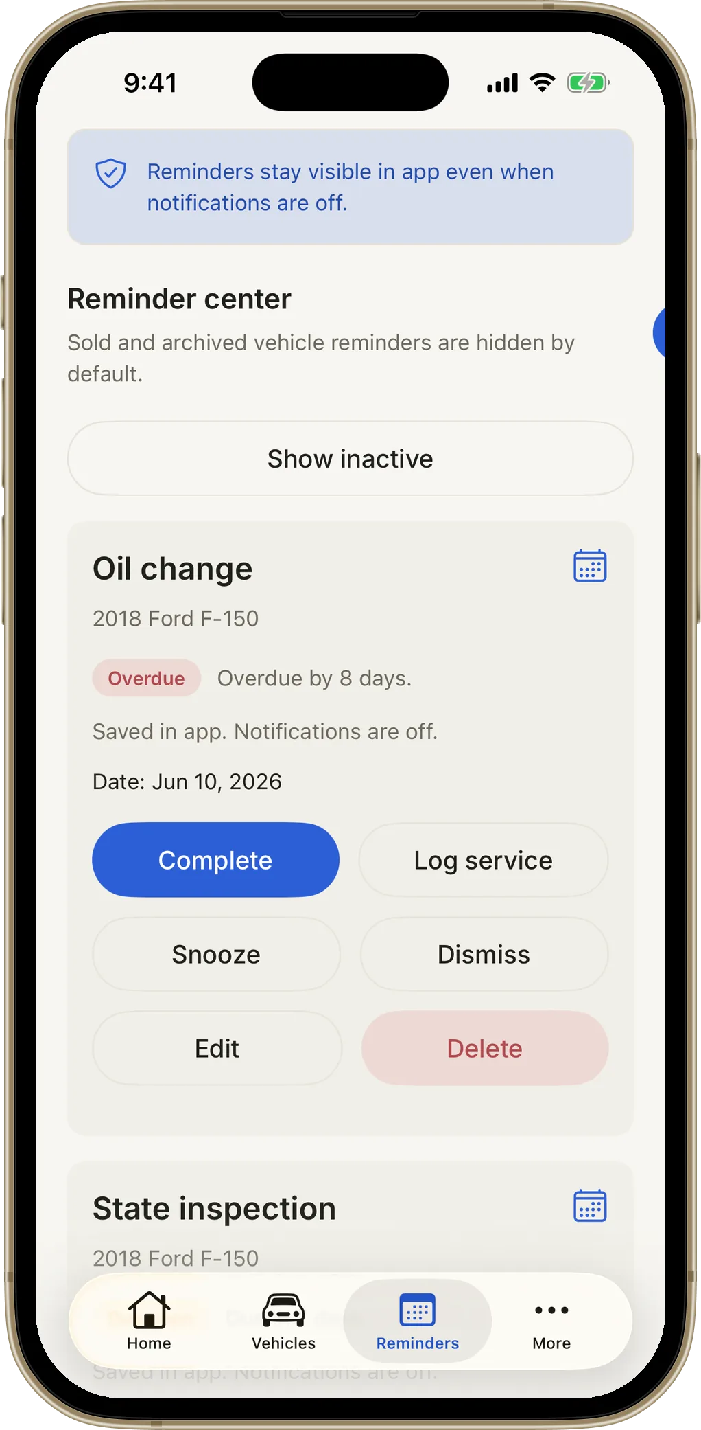 Reminders screen showing an overdue oil change with complete, snooze and log-service actions